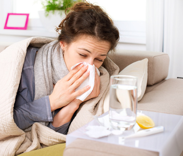 Flu or Cold. Sneezing Woman Sick Blowing Nose